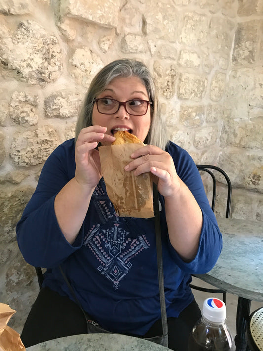 Woman dining solo at an elegant restaurant, savoring a fine meal and the freedom of solo travel